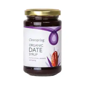 Organic date syrup in glass jar, ideal for baking and hot drinks.